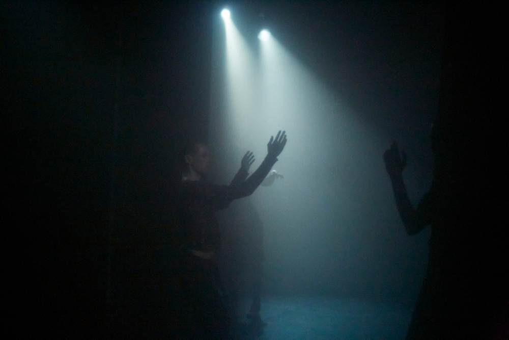 Des danseurs lèvent les bras au ciel dans une lumière à contre jour, création lumière de Jérôme Baudouin, créateur lumière en danse, théâtre et spectacle vivant